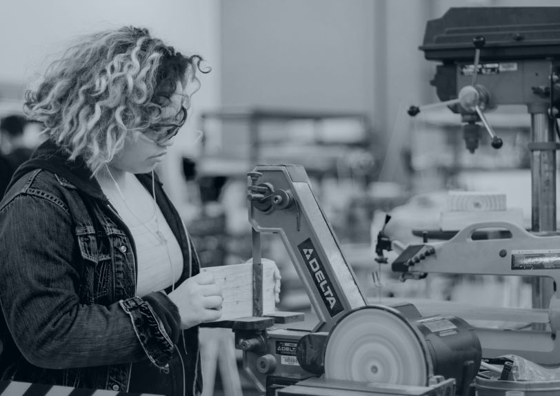 Image of student using machine tools. 